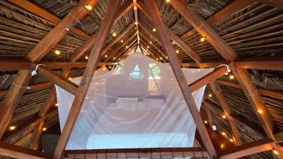 Vista frontal de la cama suspendida dentro de la estructura de madera.